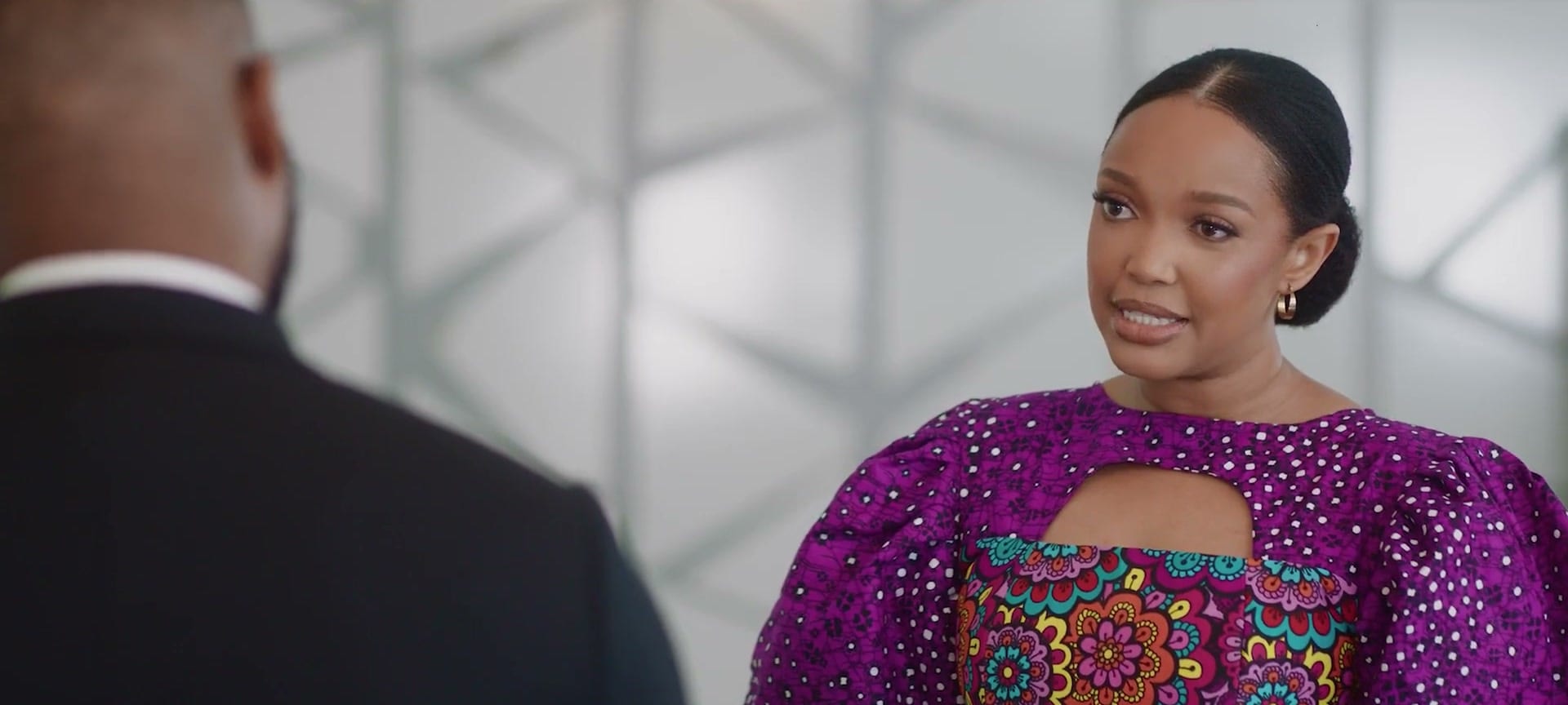 A woman in a vibrant purple dress from Strong